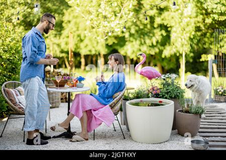 Stylish couple spend summer time at the backyard Stock Photo
