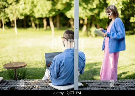Couple work on laptop computer on nature Stock Photo