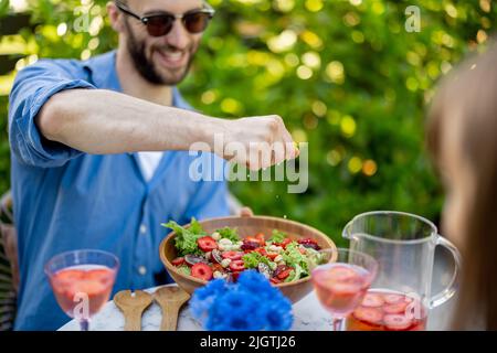 Young family having healthy lunch at backyard Stock Photo