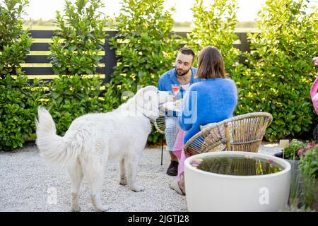Young family relaxing at backyard during summer time Stock Photo