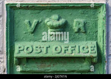 Close-up of green VR metal box with the wording of Post Office on the wall. Arklow. Ireland. Stock Photo