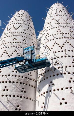 Worker cleaning bird tower from  booth of the crane in Doha. Qatar Stock Photo