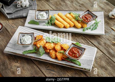 Portion of fried appetizers with sauces Stock Photo