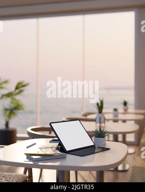 Portable tablet white screen mockup with wireless keyboard, eyeglasses, book and decor on wood table in modern comfortable coffee shop seating area. c Stock Photo