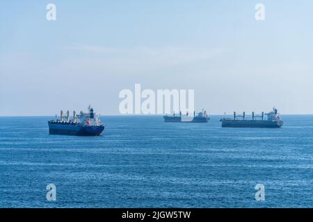 Three bulk cargo freighters at anchor in the harbor at Antofagasta, Chile. Stock Photo