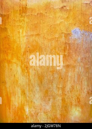 Surface of an old wall painted in orange as rough grunge background Stock Photo