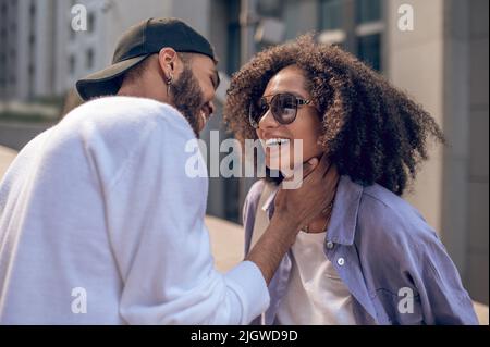 Young man and young woman flirting and looking excited Stock Photo
