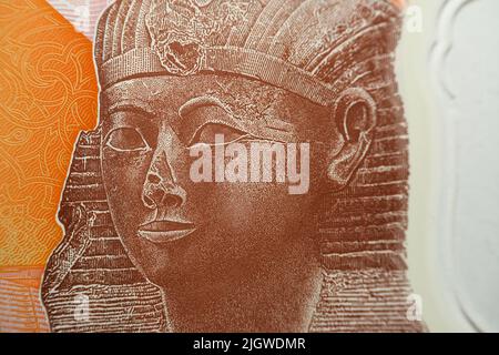 Queen Hatshepsut closeup view from the reverse side of the new first Egyptian 10 LE EGP ten pounds plastic polymer banknote with a part of the great p Stock Photo
