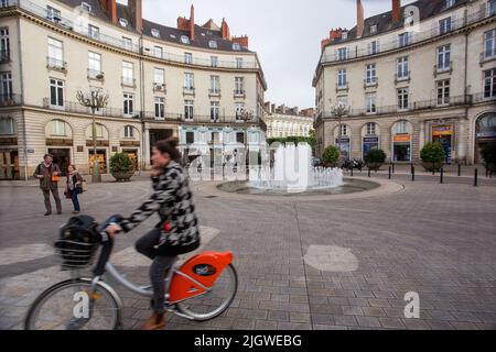 05-09-2016  Nantes  France. Downtown of Nantes -  blurred woman on bicycle and  building and  fountain Graslin Stock Photo