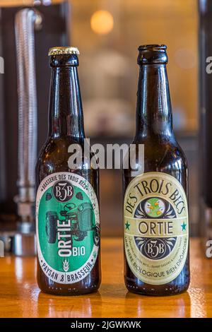 The tractor as a symbol of one's claim to act as both farmer and brewer is found on the new labels of Trois Becs. Trois Becs Brewery in Beaufort-sur-Gervanne, France Stock Photo