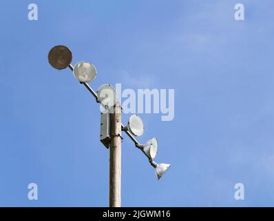 Lamp post of spotlights public stadium on blue sky Stock Photo