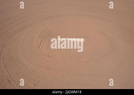 tan brown freshly raked clay diamond field area with pitcher's mound Stock Photo