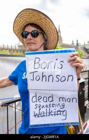 London, UK.  13 July 2022.  An anti-Tory protester holds up a sign in Parliament Square as Boris Johnson, outgoing Prime Minister attends Prime Minister’s Questions (PMQs) at the House of Commons.  Voting to select one of eight candidates to replace him as Conservative Party Leader and Prime Minister begins later today.  Credit: Stephen Chung / Alamy Live News Stock Photo