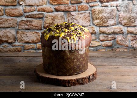 Tradidional Italian Christmas Cake Panettone on wooden rustic background. Homemade artisan sourdough pannetone ready for eating Stock Photo