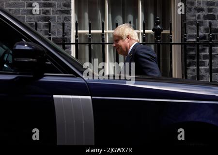 (220713) -- LONDON, July 13, 2022 (Xinhua) -- British Prime Minister Boris Johnson leaves 10 Downing Street for Prime Minister's Questions in London, Britain, July 13, 2022. Boris Johnson resigned as British prime minister and the leader of the Conservative Party in a statement to the country on July 7.   The new prime minister of the United Kingdom (UK) replacing incumbent Boris Johnson will be announced on September 5, said Graham Brady, chairman of the Conservative Party's backbench 1922 Committee, on Monday. (Photo by Tim Ireland/Xinhua) Stock Photo