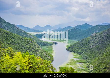Canyon of Rijeka Crnojevica river near the Skadar lake coast. One of the most famous views of Montenegro. River makes a turn between the mountains and Stock Photo