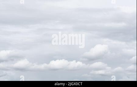 White cumulus clouds on gray sky texture background. Full frame of cloudscape background. Cloudy sky. Beauty in nature. White fluffy clouds. Nature Stock Photo
