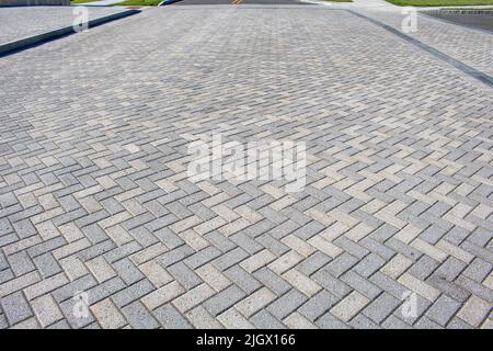 white and grey harring patterned brick floor pavement outdoors Stock Photo