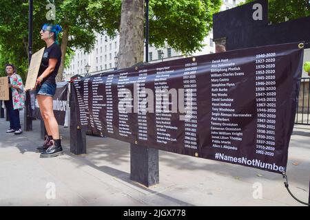 London, England, UK. 13th July, 2022. Campaigners from the organisation Names Not Numbers hung banners with names of people who lost their lives to coronavirus outside Downing Street as UK covid deaths surpass 200,000. (Credit Image: © Vuk Valcic/ZUMA Press Wire) Stock Photo