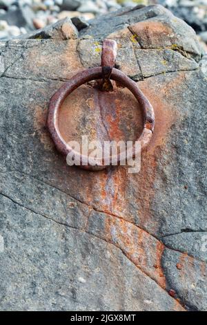 Rusty metal ring on rock on beach, Holy Island, Northumberland, England, United Kingdom, Europe Stock Photo