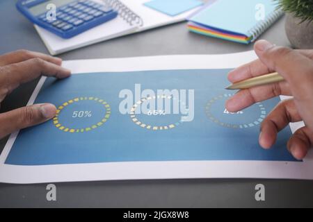 man hand with pen analyzing financial data pov  Stock Photo