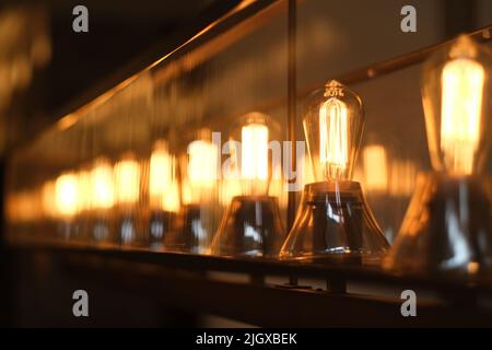 a row of retro light bulbs at night. diminishing perspective Stock Photo