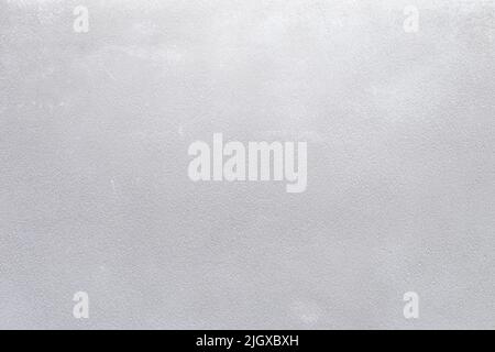 Plastered concrete or stone wall painted in white, front view. High resolution full frame textured background. Copy space. Stock Photo