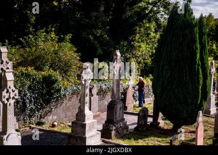 Irish crosses being tended at a graveyard in Virginia, Ireland. Stock Photo