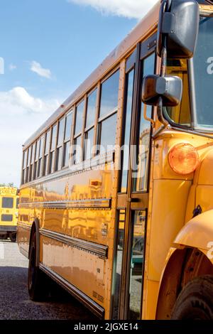 Big Yellow School Bus are parked, clean and shiny waiting to bring the kids or children to school. Stock Photo