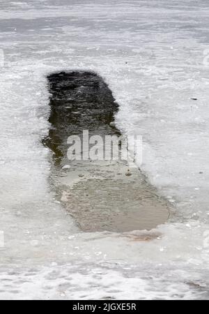 Large ice hole in the lake in winter for swimming Stock Photo