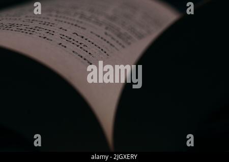 Book pages close up. Macro photography in warm colors is suitable as a background on the topics of reading, literature, book business, Stock Photo