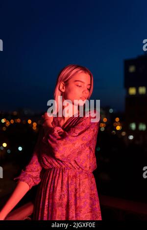 Woman in a dress on the background of the night city Stock Photo