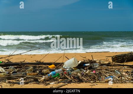 Plastic and wood waste on the beach pollute the environment. Negombo, Sri Lanka. Stock Photo