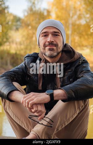 handsome smiling man in jacket coat in autumn Stock Photo