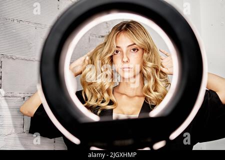Portrait of woman showing freshly combed hair at hair salon Stock Photo