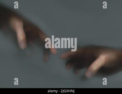 Two hands reaching out to each other in the mist Stock Photo