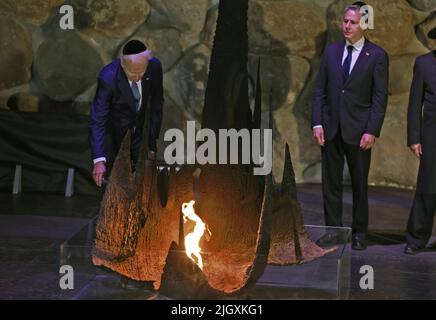 Tel Aviv, Israel. 13th July, 2022. rekindles the Eternal Flame at the Hall of Remembrance during a visit to the Yad Vashem Holocaust Memorial museum in Jerusalem, as US Secretary of State Antony Blinken looks on in Jerusalem on Wednesday, July 13, 2022. Pool Photo by Menahem Kahana/UPI Credit: UPI/Alamy Live News Stock Photo