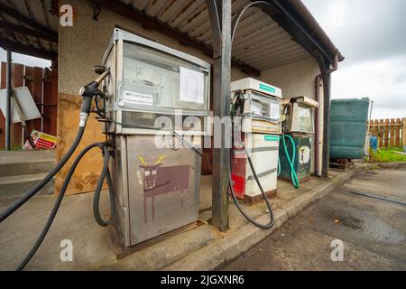 Old fuel pumps in Kilchoan, Scotland, UK. There is one diesel and two unleaded petrol/gas pumps. The pumps are very old and are run by an attendant Stock Photo