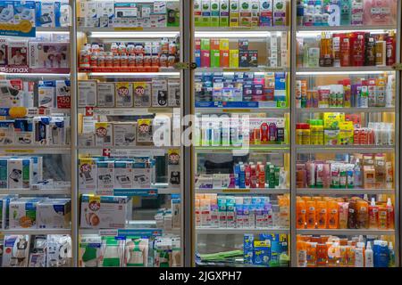 Mariupol, Ukraine - July 15, 2021: Pharmacy shelves full of different products closeup. Medicines arranged in windows shelves. Medicines and vitamins Stock Photo