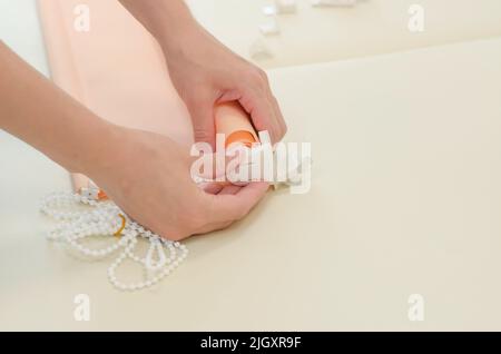 Women's hands are assembling roller blinds, close-up. Assembly of roller blinds Stock Photo