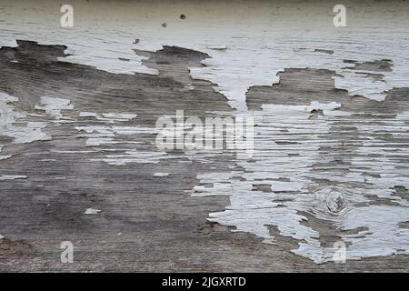 Abstract peeling old paint pattern on weathered wood surface Stock Photo