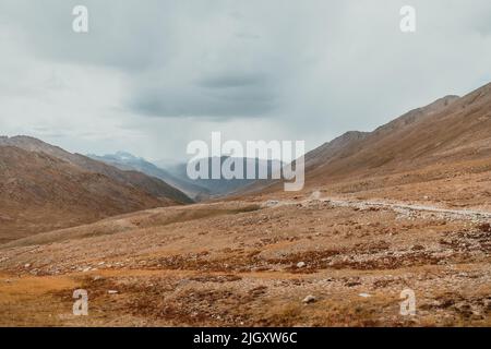 dark thunderstorm clouds over the mountains of Deosai National Park in Pakistan Stock Photo