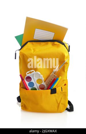 Backpack with school supplies, isolated on white background Stock Photo