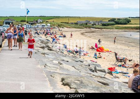 Garrylucas, West Cork, Ireland. 13th July, 2020. People made the most of the sunshine this morning as early temperatures hit 21C on Garrylucas Beach, West Cork. Met Éireann has forecast increasingly higher temperatures for the rest of the week culminating in a possible 28C at the weekend. Credit: AG News/Alamy Live News Stock Photo