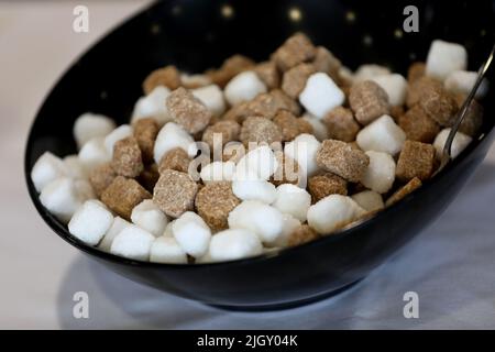 A load of sugar cubes in a bowl in Chichester, West Sussex, UK. Stock Photo