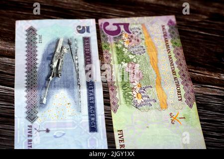 Saudi Arabia 5 SAR five Saudi riyals cash money banknote features flowers and Ras Tanura tanker loading terminal, Jubayl Port, Eastern Province isolat Stock Photo