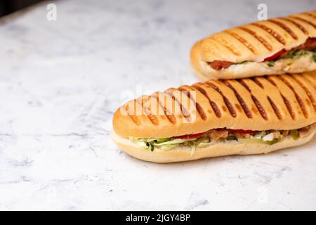 panini with filling. three panini on a white background. Stock Photo