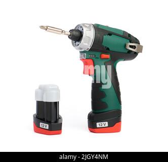Professional cordless screwdriver and spare battery close up on white background Stock Photo