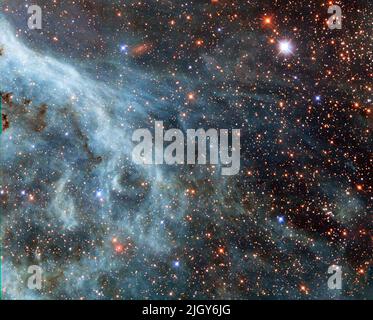 Space. 13th Oct, 2014. The brightly glowing plumes seen in this image are reminiscent of an underwater scene, with turquoise-tinted currents and nebulous strands reaching out into the surroundings. However, this is no ocean. This image actually shows part of the Large Magellanic Cloud (LMC), a small nearby galaxy that orbits our galaxy, the Milky Way, and appears as a blurred blob in our skies. The NASA/ESA Hubble Space Telescope has peeked many times into this galaxy, releasing stunning images of the whirling clouds of gas and sparkling stars (opo9944a, heic1301, potw1408a). This image sh Stock Photo