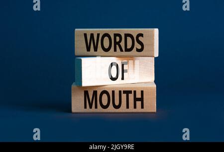 Words of mouth symbol. Concept words Words of mouth on wooden blocks on a beautiful grey table grey background. Business, finacial and words of mouth Stock Photo